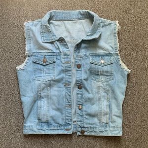 Distressed denim vest in a size S